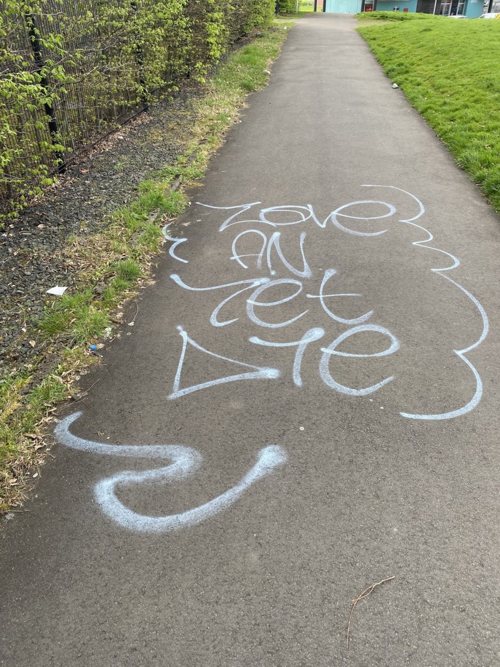 graffiti, the words LOVE AND LET DIE painted on a walking path